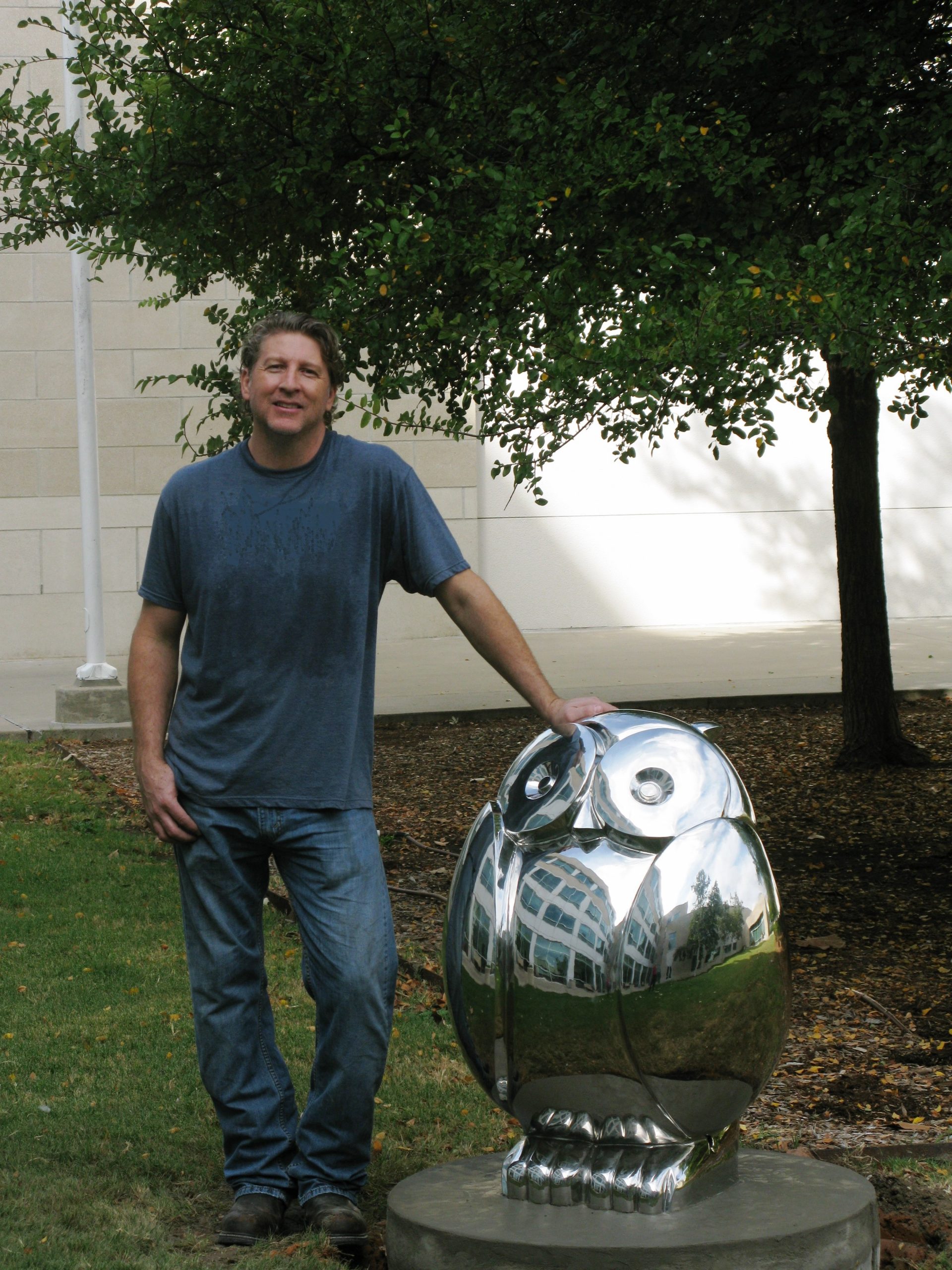Artist Brad Oldham with his creation, Wise