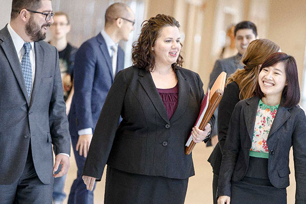 UT Dallas mba students walking in the Jindal School, Part-Time MBA Conference