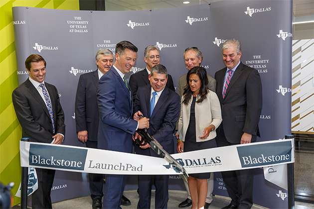 The ribbon-cutting for UT Dallas Blackstone LaunchPad included (back row, from left) Bryan Chambers, program director; Dr. Hasan Pirkul, dean of the Jindal School; Dr. Mark Spong, dean of the Erik Jonsson School of Engineering and Computer Science; Steve Guengerich, executive director of the Institute for Innovation and Entrepreneurship; John Bartling Jr., president and CEO of Invitation Homes; (front row, from left) Rafael Martín, interim vice president for research; Bill Stein, Blackstone’s senior managing director of real estate; and Alisha Chaudry Slye, global director of Blackstone LaunchPad.