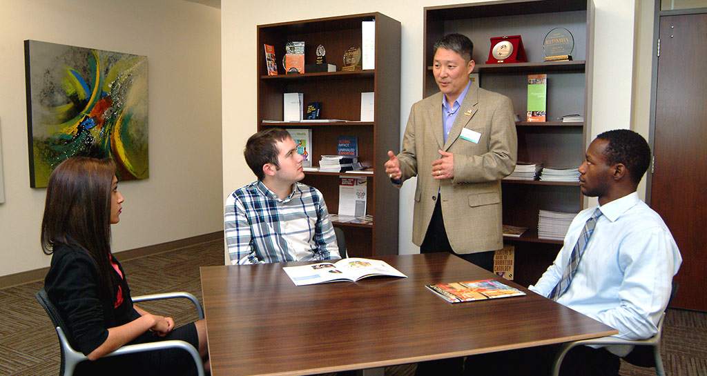 Tom Kim with students