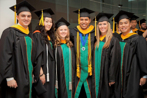 Students celebrating their graduate degree with academic honors