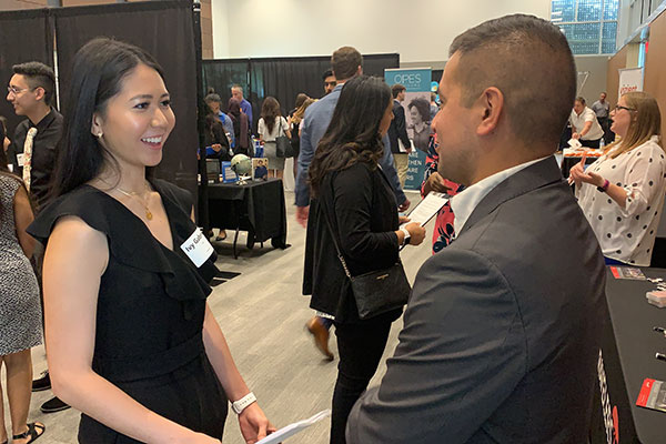 Jindal School student at a career event talking to a recruiter about applying for a job