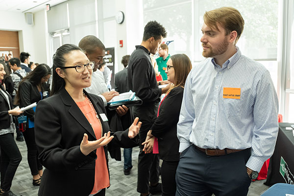 Students at JSOM mingle at a career management center recruitment event.