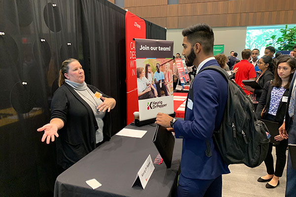 Jindal School student meeting with employer at a UT Dallas career fair
