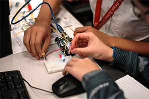 students working with an Arduino board at HackIT
