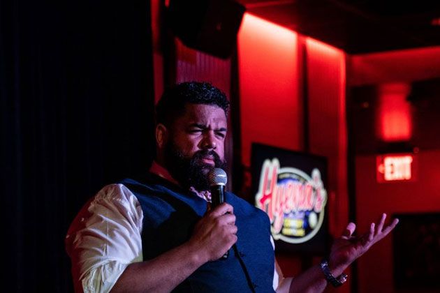 Jonathan Jones performing stand-up comedy at the Hyena’s Comedy Nightclub