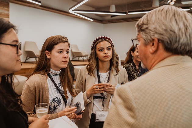 Duyen Nguyen, an accounting senior in the Jindal School, and other UT System students speak with David Matthews, managing director of Revtech Ventures