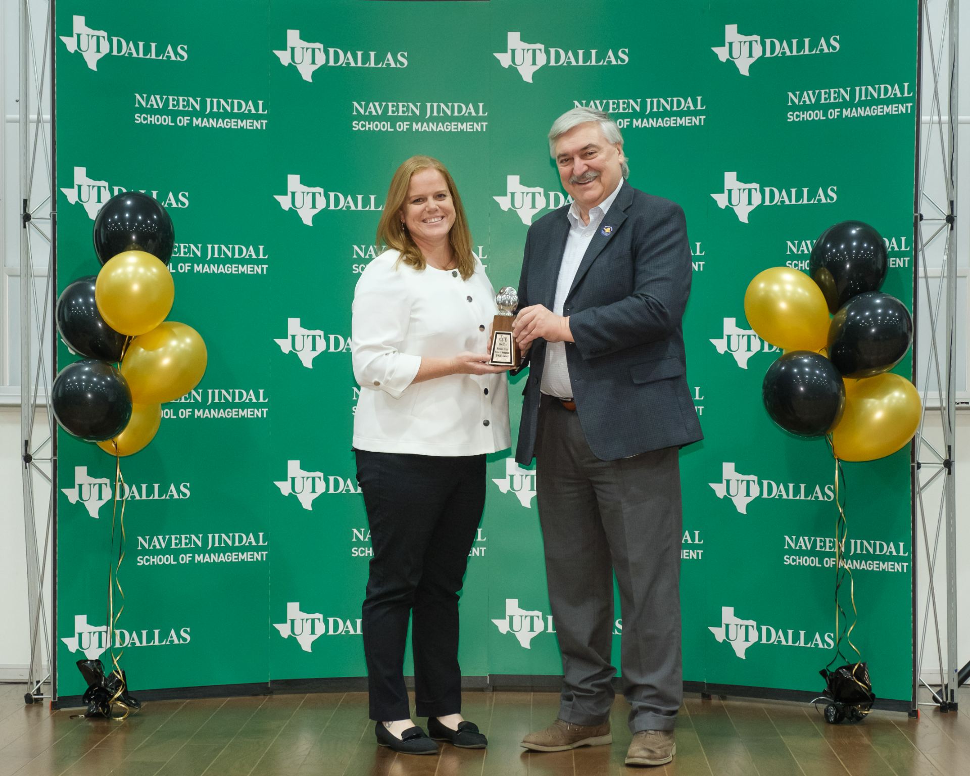 JSOM Master's Student Haley Randell accepts 2023 Owlie for Student of the Year from Dean Pirkul.