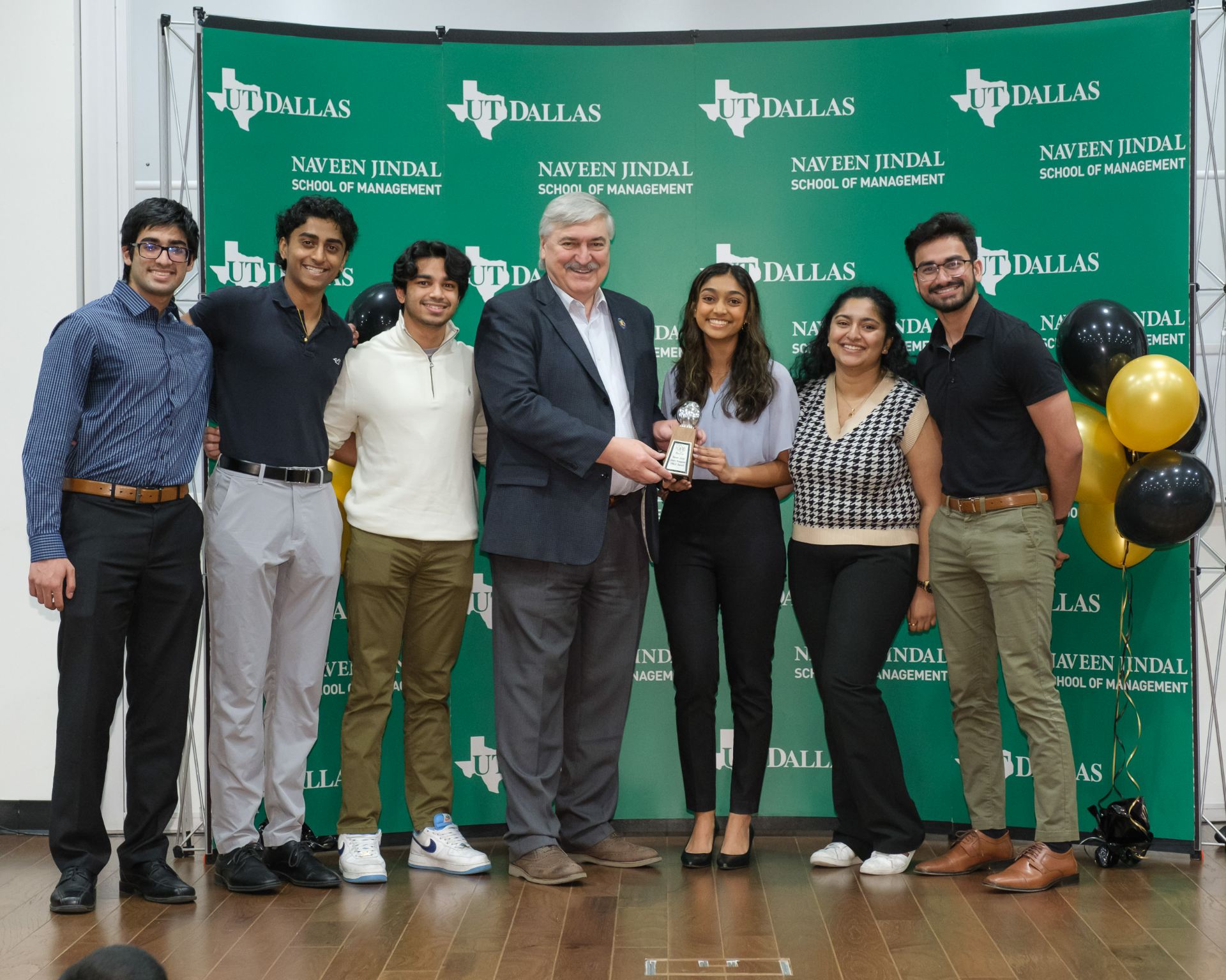 1JSOM Undergraduate Student Organization Financial Leadership Association accepts 2023 Owlie Award for Best Student Organization from Dean Hasan Pirkul.