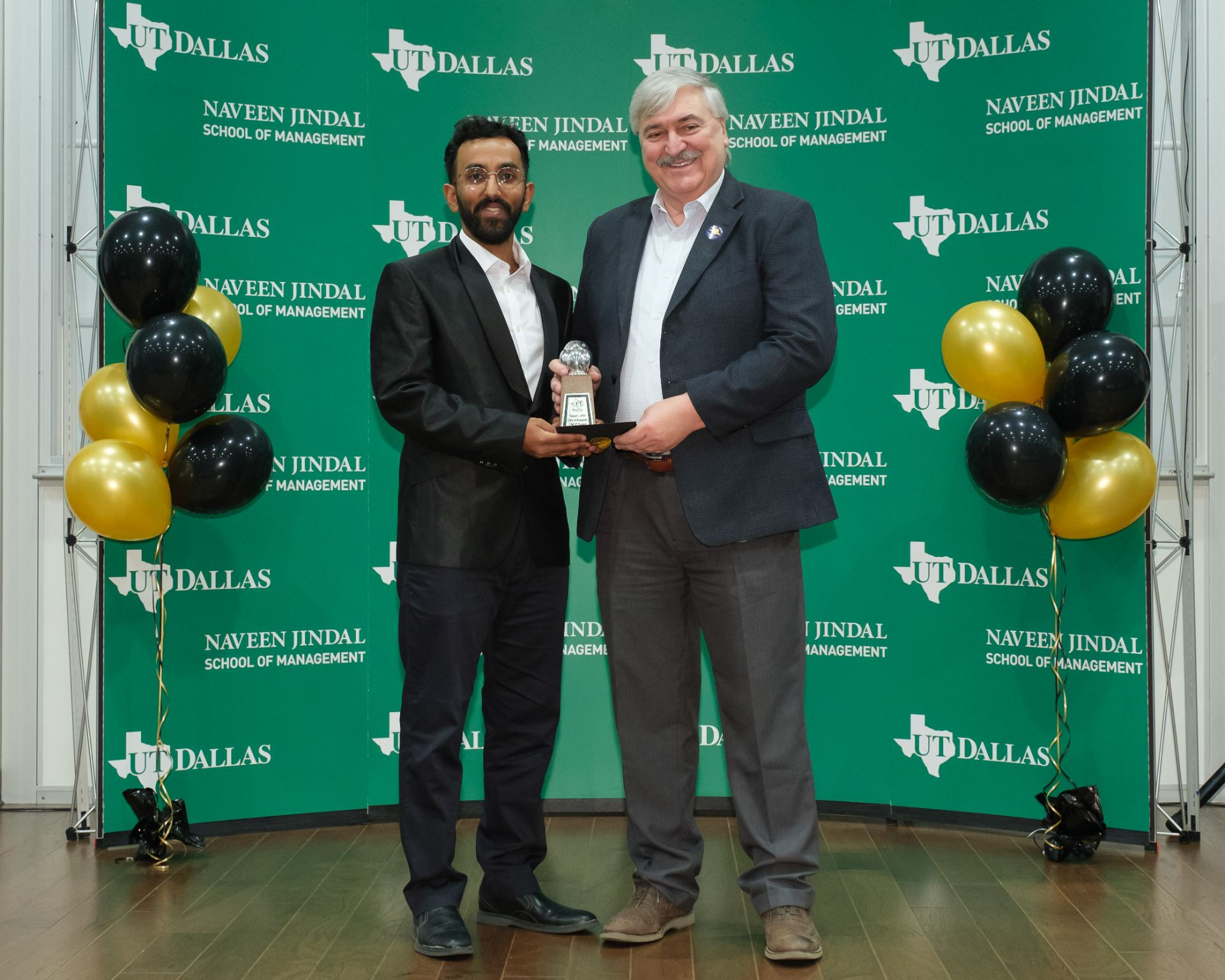 JSOM student Nimish Sharma accepts the 2023 Owlie Award for Selfless Service from Dean Hasan Pirkul.
