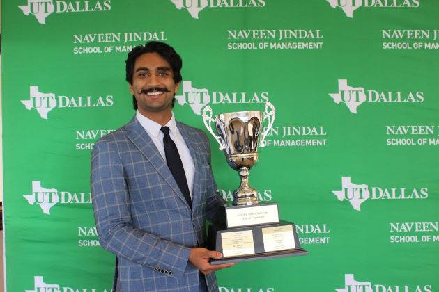 Kyro Abraham holding his Overall Pro Sales Championship trophy at the JIndal School's 2023 Speed Sell presented by the Center for Professional Sales