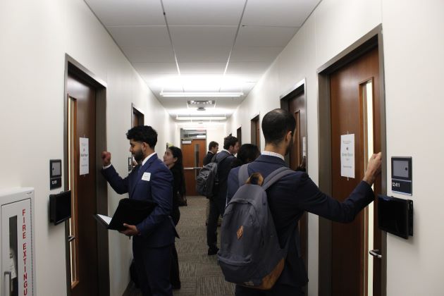 Advanced Sales students knocking on the doors of their first roleplays at the 2023 Pro Sales Challenge, presented by the Center for Professional Sales at the Naveen Jindal School of Management