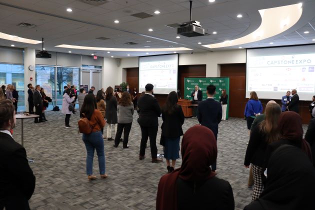 Photo of Dean Hasan Pirkul welcoming participants at the UTDsolv Capstone Expo – Fall 2023