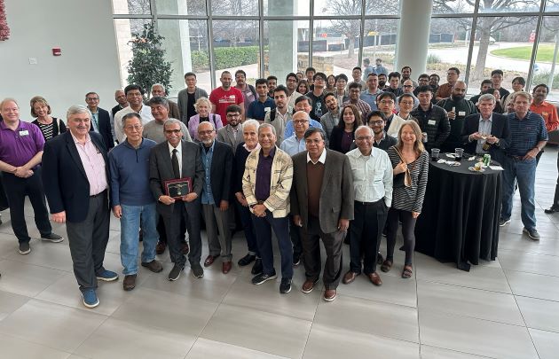 Photo of attendees converging in the ECLAT Atrium at a reception to celebrate the historic presentation of the Jindal School's inaugural Eminent PhD Alumnus Award to Dipak Jain (front row, third from left)
