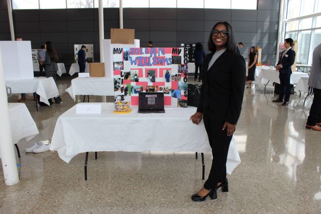 Photo of Advanced Selling student Jordan Williams at her Reverse Job Fair booth