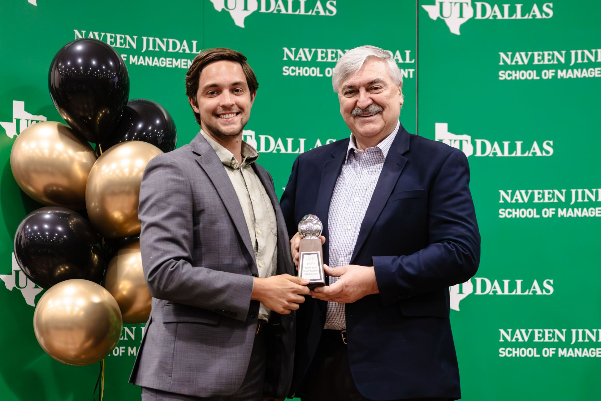 Dean Pirkul presents Graduate Student of the Year OWLIE award to Griffen Henderson