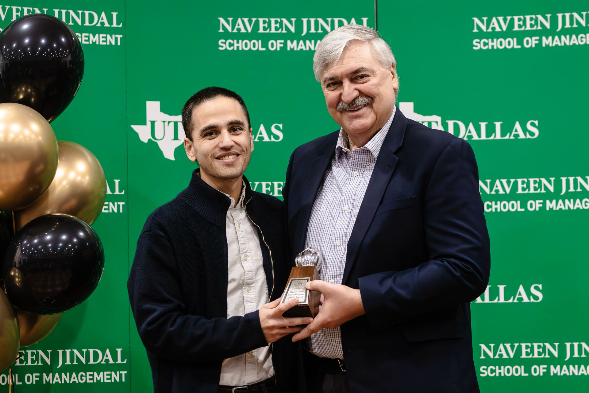 Dean Pirkul presents Graduate Faculty of the Year OWLIE award to Ignacio Rios Uribe.