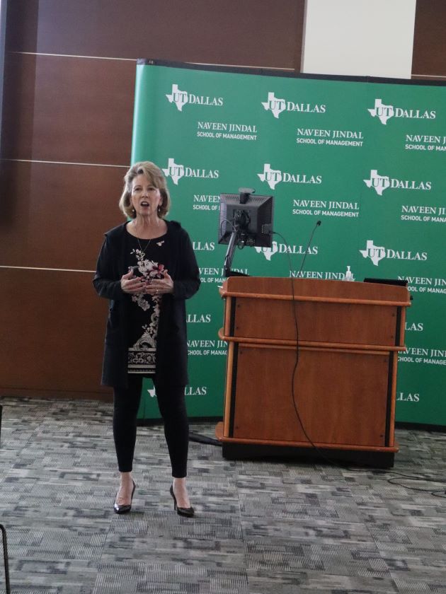 Photo of Monica Powell welcoming attendees of "Neurodiversity at Work: The Employee Experience" held April 19, 2024 at the Naveen Jindal School of Management.