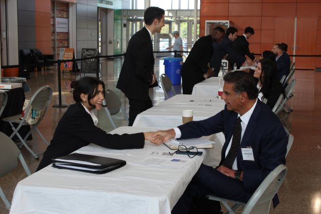 Marketing Junior Tia Salins shaking Usman Sheikh’s (CEO of Xiq) hand during Speed Sell at the 2023 Pro Sales Challenge, presented by the Center for Professional Saless