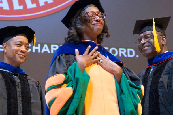 TCarliss (Charles) Miller (center), PhD’16, with Drs. Orlando Richard (left) and David L. Ford Jr. at her hooding ceremony